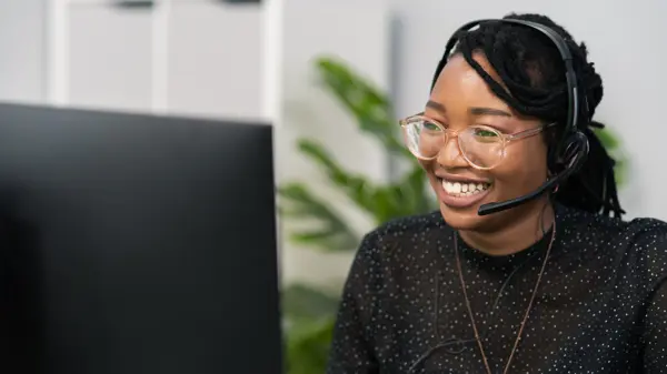 Black woman communicating on the phone, positive expression