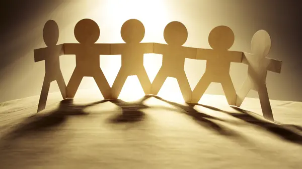 paper chain people in a row holding hands