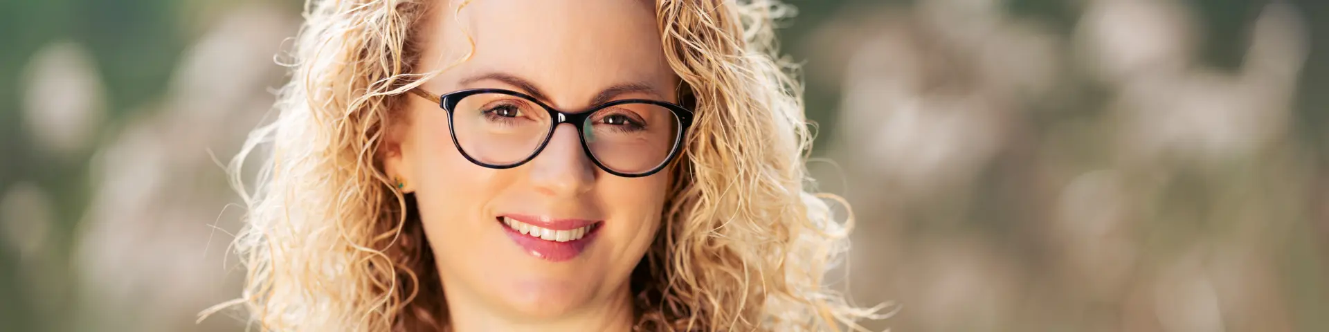 Photo of Nicola Green, smiling woman with blonde curly hair