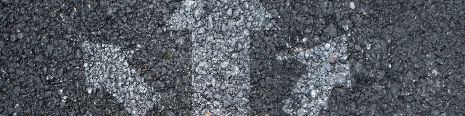 Arrows in different directions painted on ground, orange trainers facing the arrows