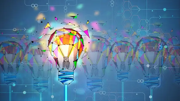 colourful creative polygonal light bulb being created by elements coming together